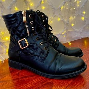Black boots with gold zipper and buckle